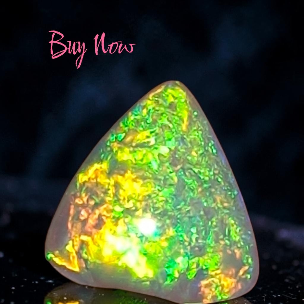 Time & Lustre triangular Australian crystal opal featuring vibrant green and yellow play-of-colour flashes.