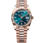Luxury watch with rose gold case and blue dial on a white background