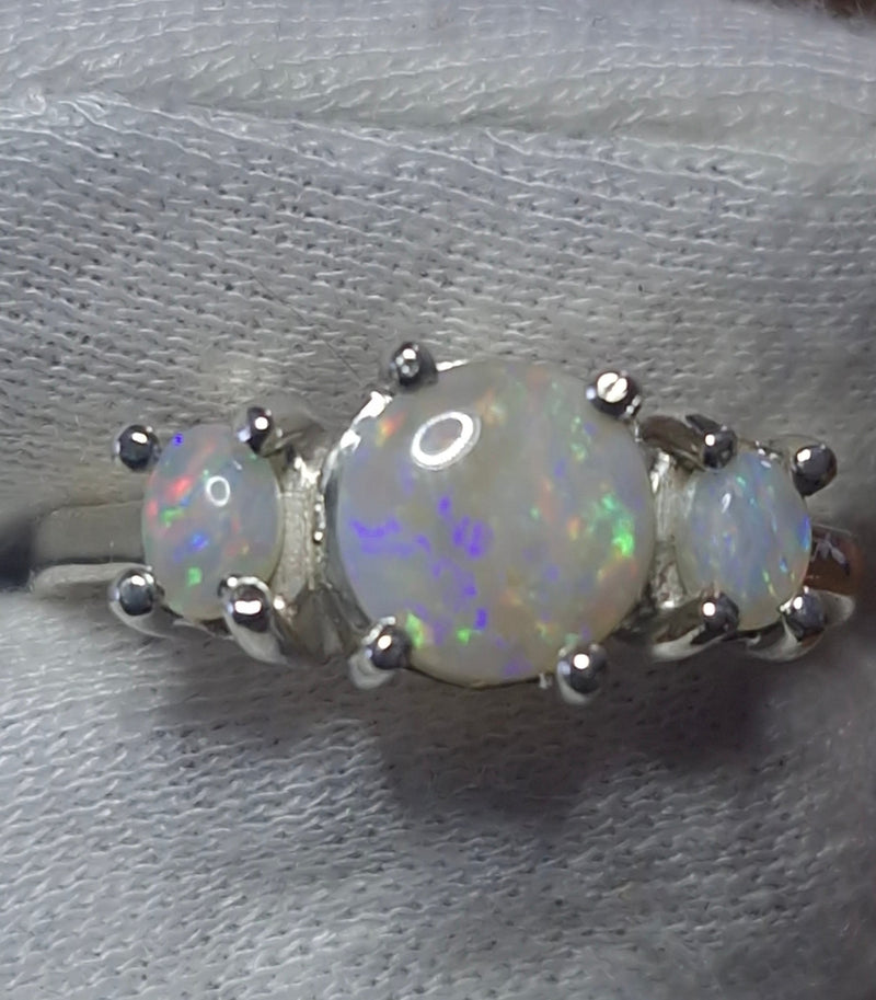 Time & Lustre three-stone Coober Pedy opal ring in sterling silver with claw settings showing vibrant colour flashes
