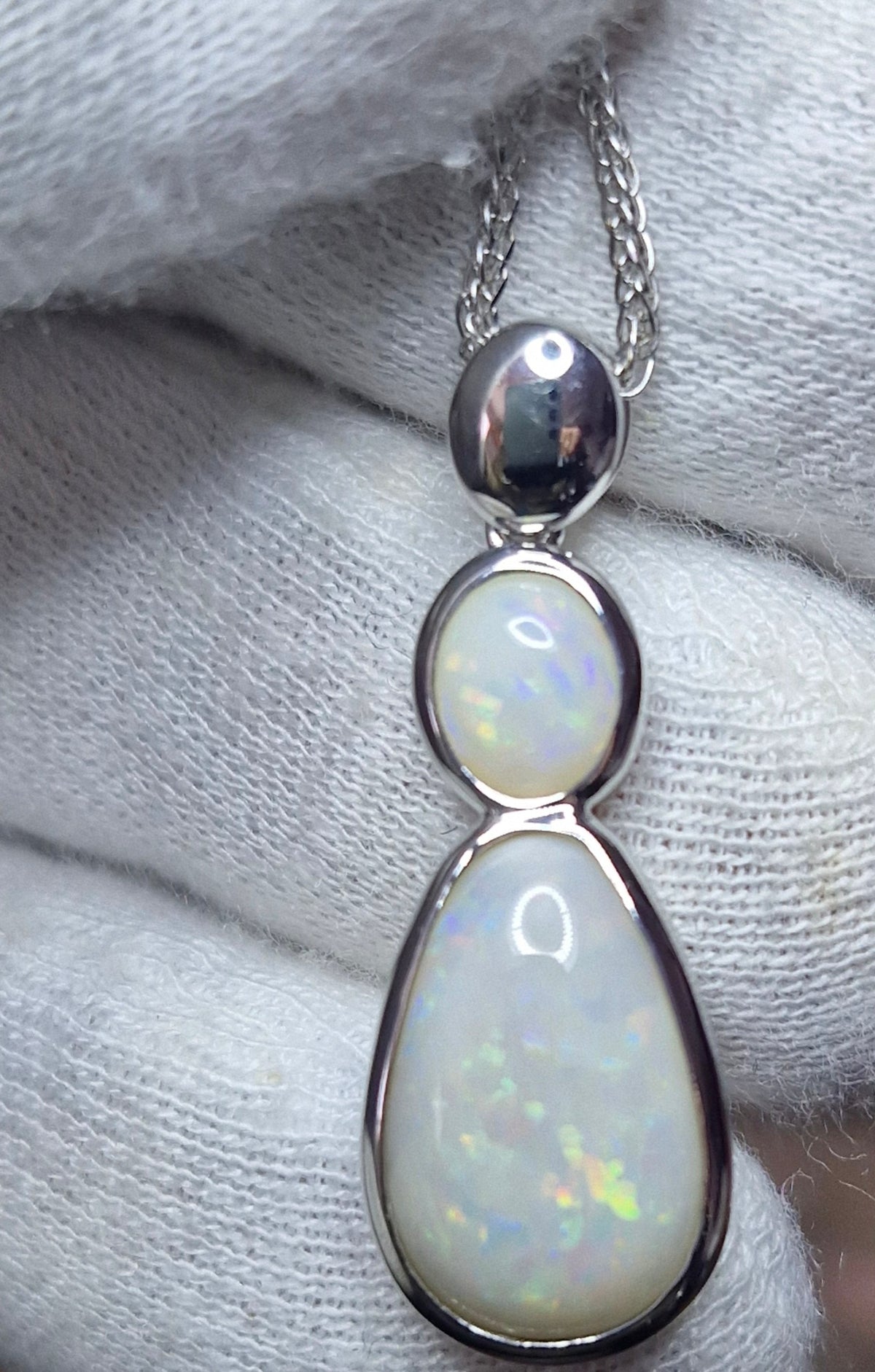 Time & Lustre double drop opal pendant necklace featuring two white opals with iridescent flashes in polished silver