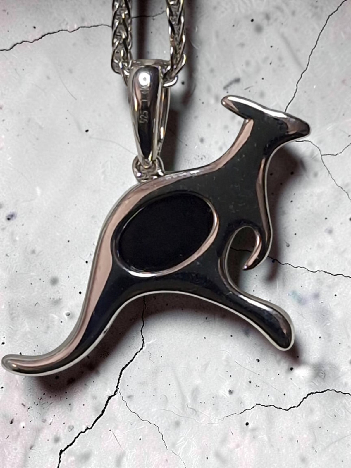 Time & Lustre sterling silver kangaroo pendant necklace featuring a dark opal inlay on a textured stone background.