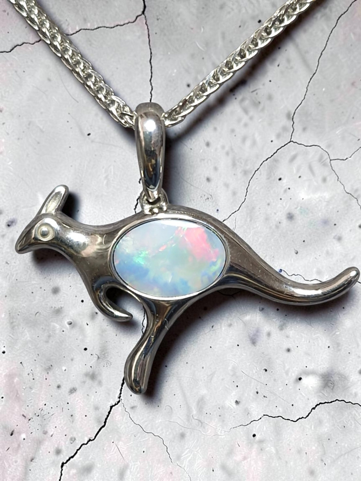 Time & Lustre sterling silver kangaroo pendant featuring a genuine opal with vibrant pink, blue, and green flashes.
