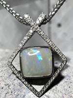 Time & Lustre Lightning Ridge opal pendant in a geometric diamond-encrusted sterling silver frame on a woven chain.
