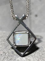 Time & Lustre sterling silver pendant featuring a Lightning Ridge opal in a geometric frame on a woven chain