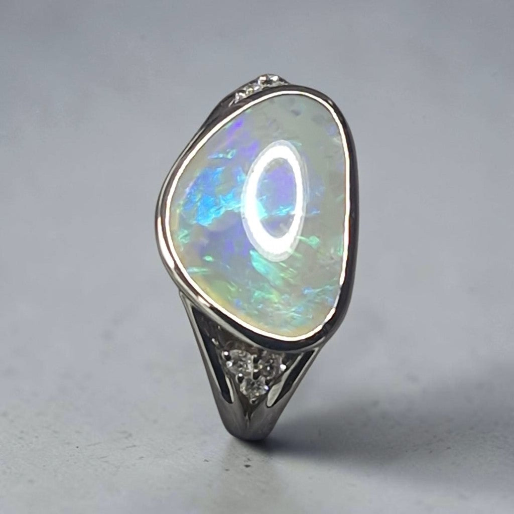 Time & Lustre sterling silver ring featuring a free-form Lightning Ridge opal with blue and green flashes and diamonds.