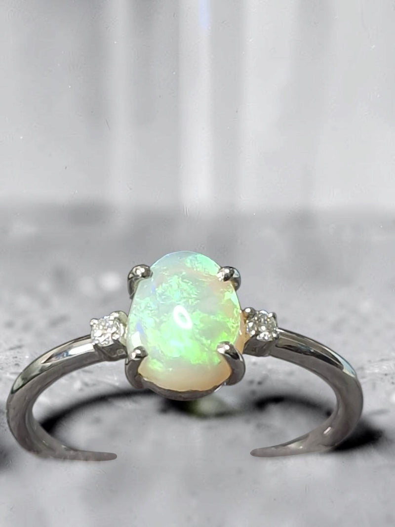 Time & Lustre oval opal ring with side accent diamonds set in a polished silver-tone band