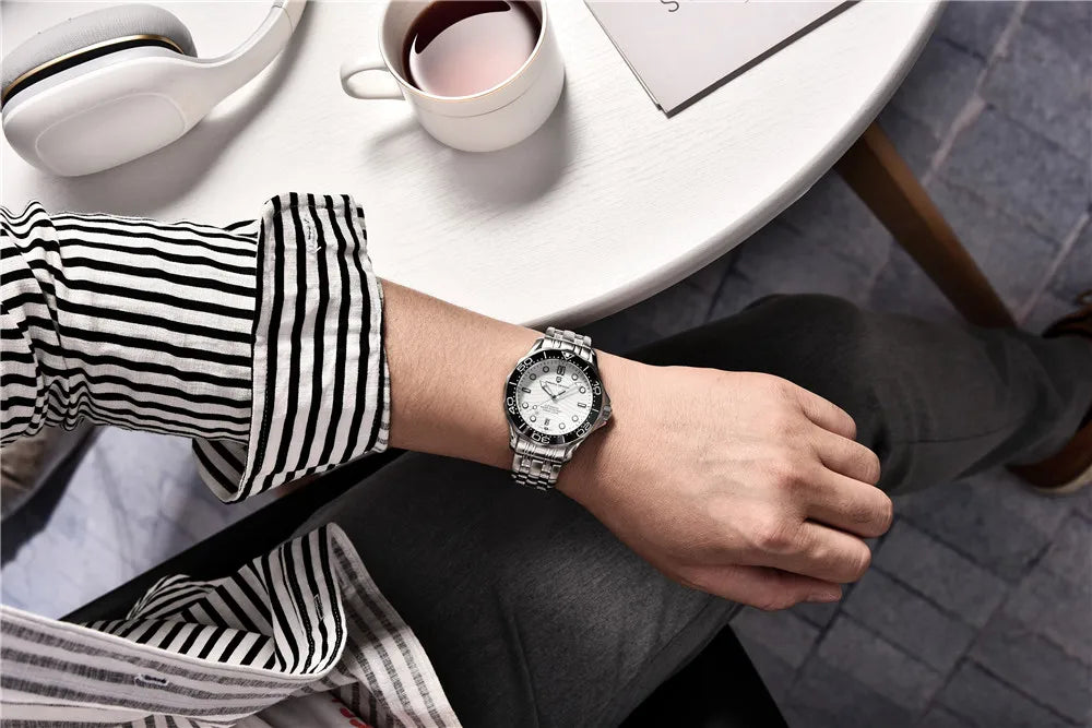 Time & Lustre Pagani Design 1685 automatic diving watch with a white dial and stainless steel bracelet on a man's wrist