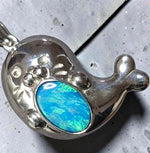 Time & Lustre sterling silver seal pendant featuring a vibrant blue and green iridescent opal inlay.