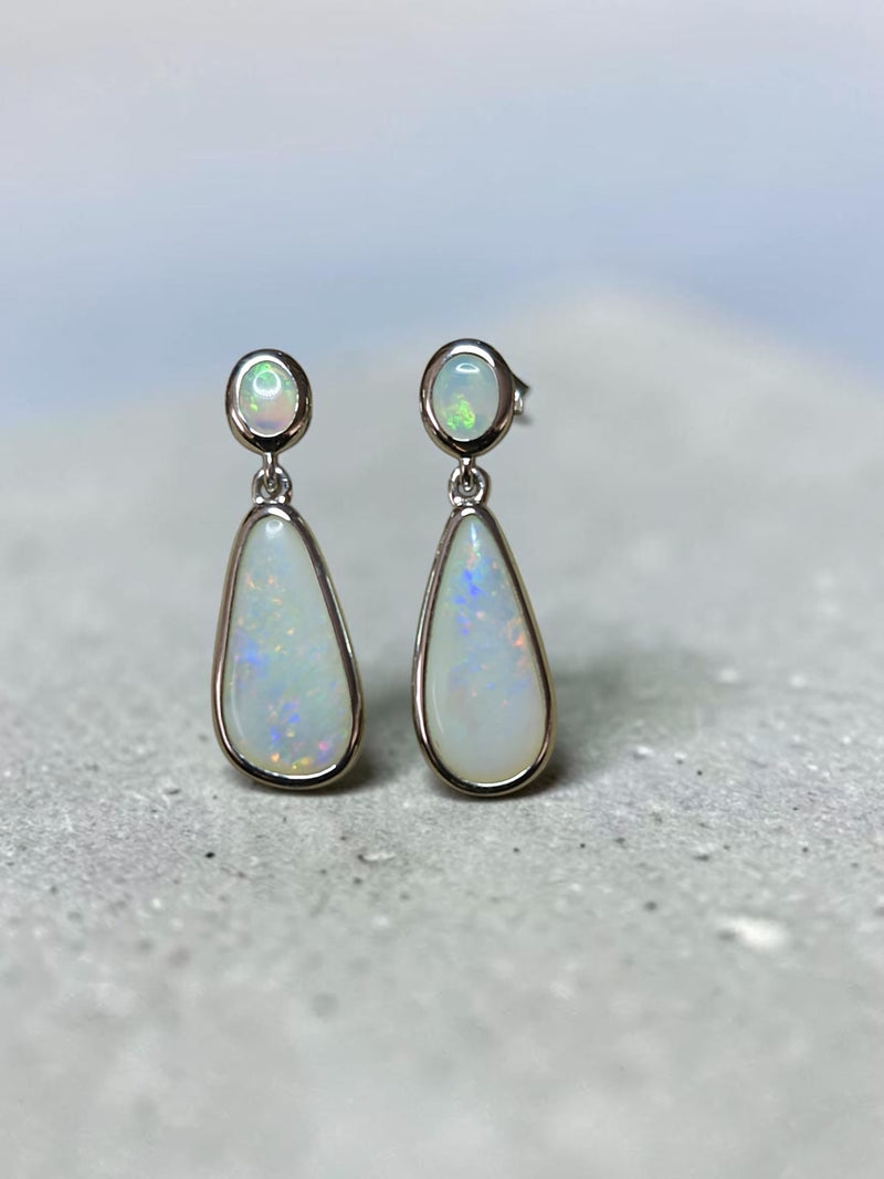 Time & Lustre teardrop opal drop earrings in polished sterling silver with oval studs and iridescent gemstone flashes.