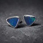 Time & Lustre triangle-cut black opal stud earrings in sterling silver featuring vibrant blue and green colour flashes.