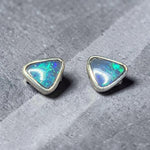Time & Lustre triangle-cut black opal stud earrings in sterling silver with vibrant blue and green colour flashes.